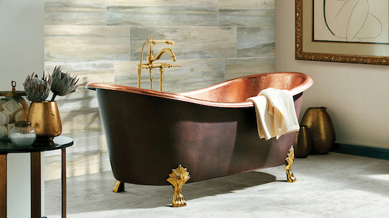 example of a bathroom remodel with waterproof tile floors, wood look tile accent wall, and a gorgeous copper tub